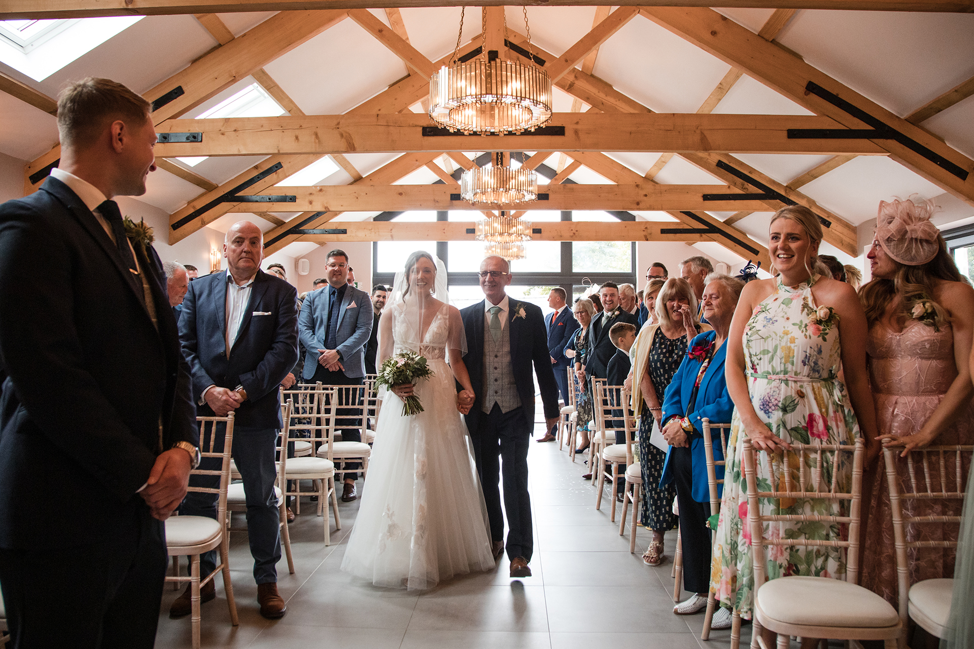 bride walking down the aisle at woodland wedding wales