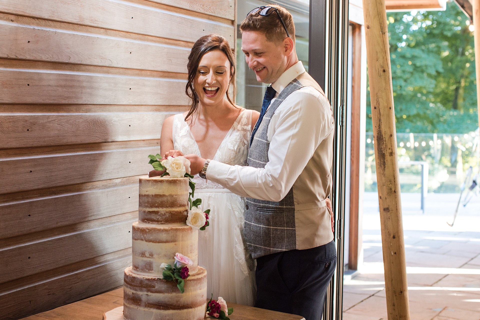 cutting the cake at woodland wedding wales