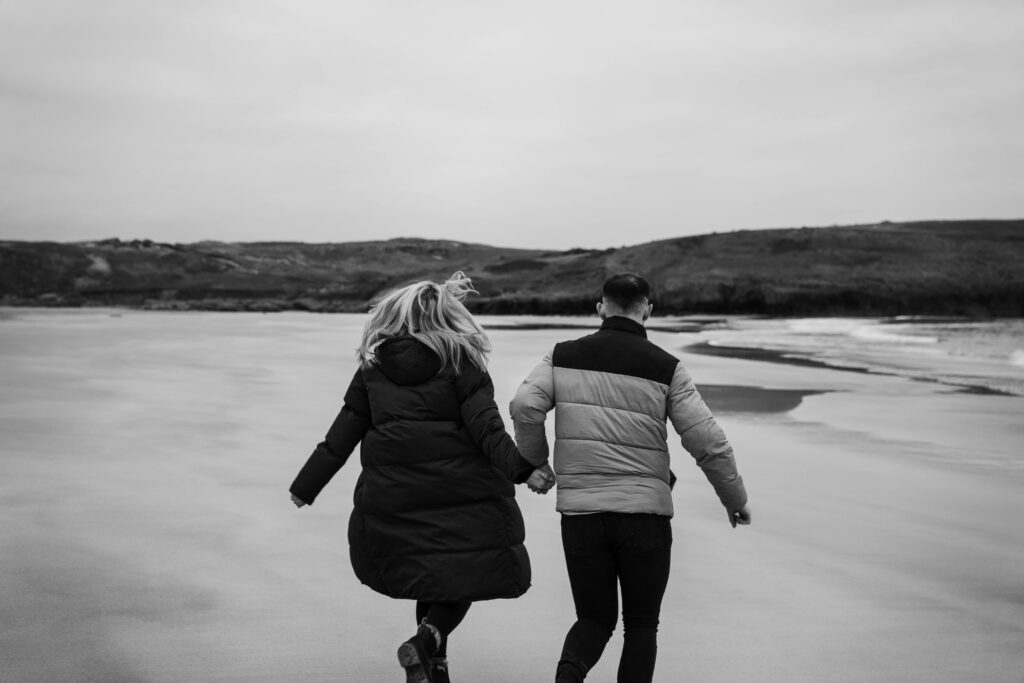 Engagement photoshoot of couple in rocks and broad haven south, Pembrokeshire West Wales 