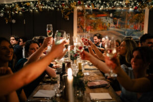 Guests raise a cheer during a festive winter wedding in Newport, Pembrokeshire