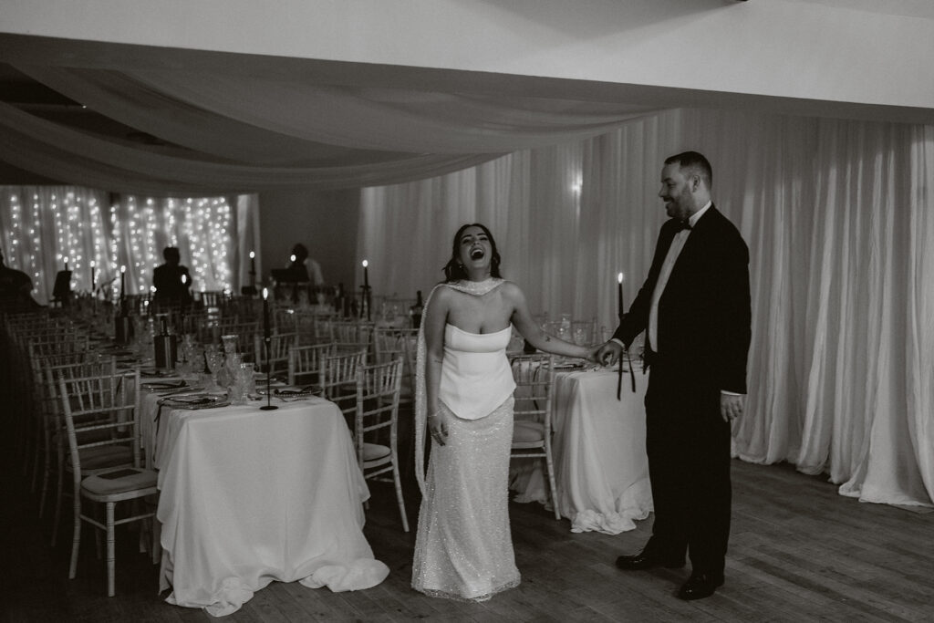 Couple photography by draped engagement dinner set up in Pembrokeshire 