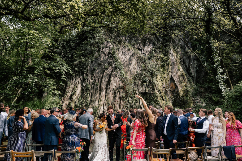Couple walking through confetti in the query in Fforest Farm