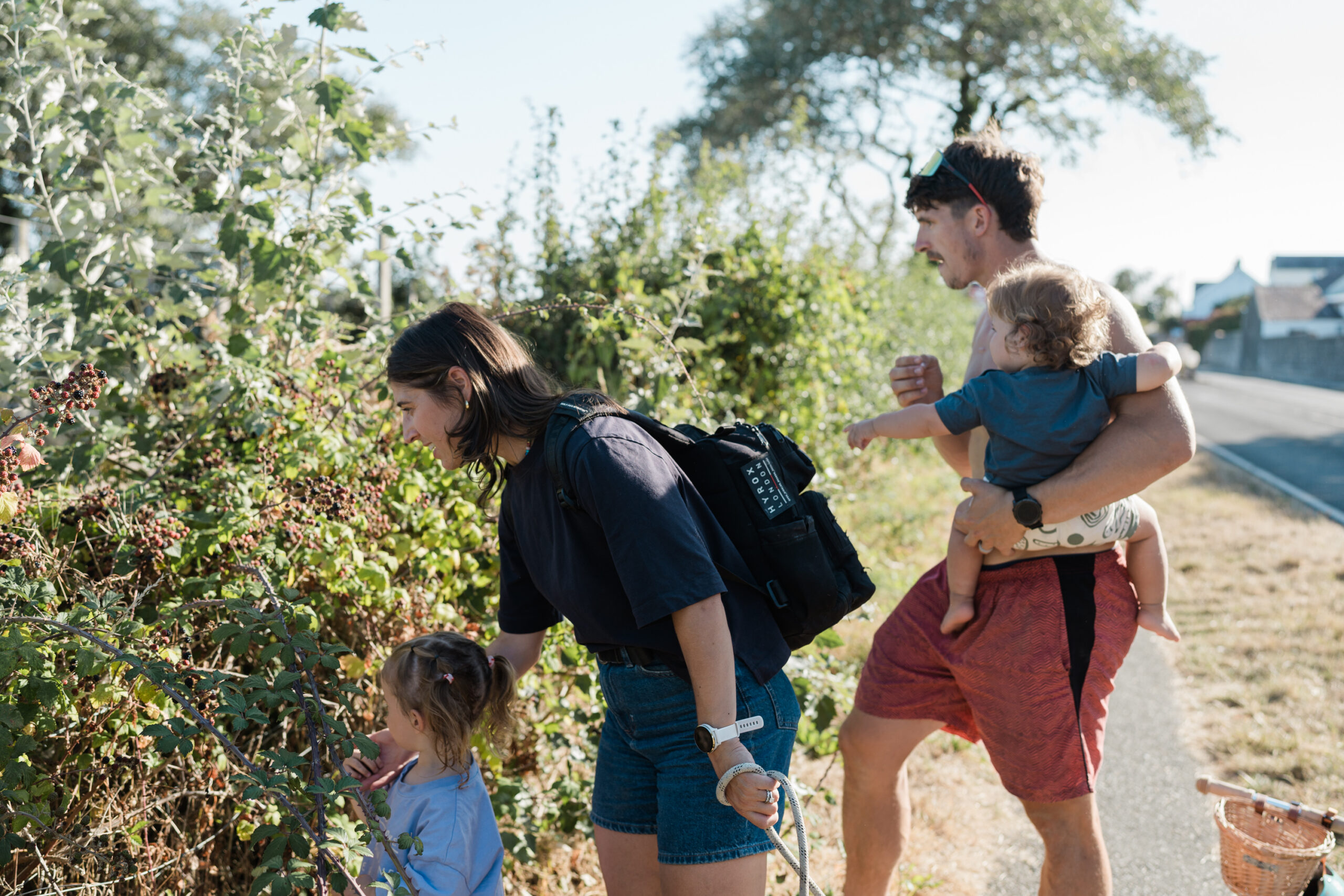 Family picking blackberries during a family photography session in Pembrokeshire